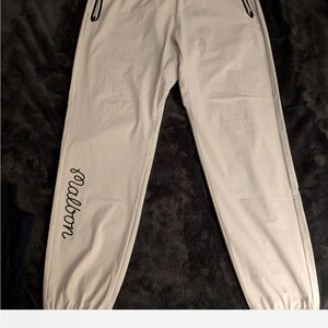 Cream colored malbon joggers with Black Script Logo